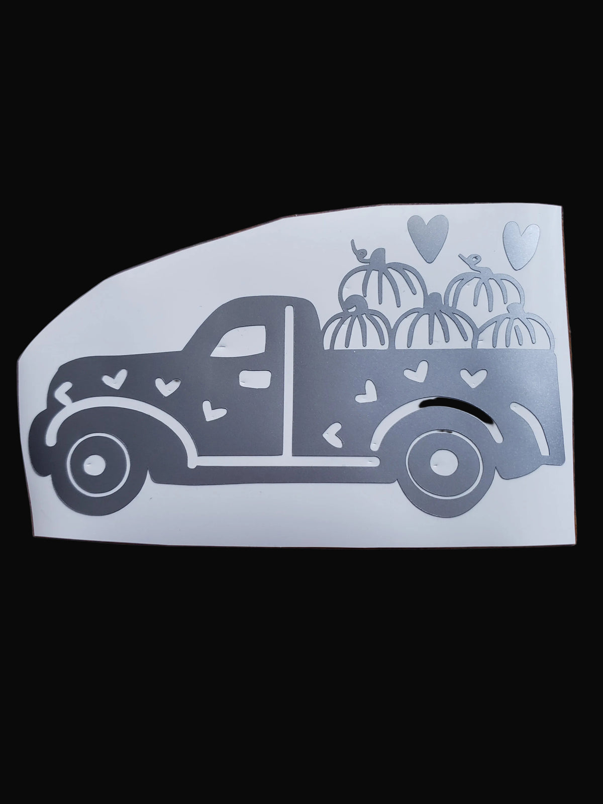 A vinyl sticker with a truck design, filled with pumpkins and decorated with hearts.
